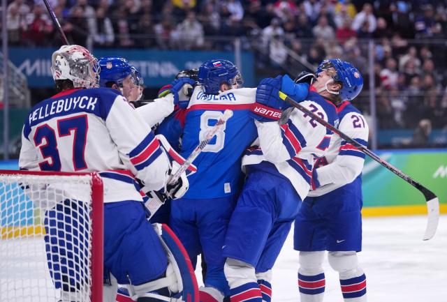 (260221) -- MILAN, Feb. 21, 2026 (Xinhua) -- Players of both teams fight during the ice hockey men's play-offs semifinal match between the United States and Slovakia at the Milan-Cortina 2026 Olympic Winter Games in Milan, Italy, Feb. 20, 2026. (Xinhua/Tao Xiyi)