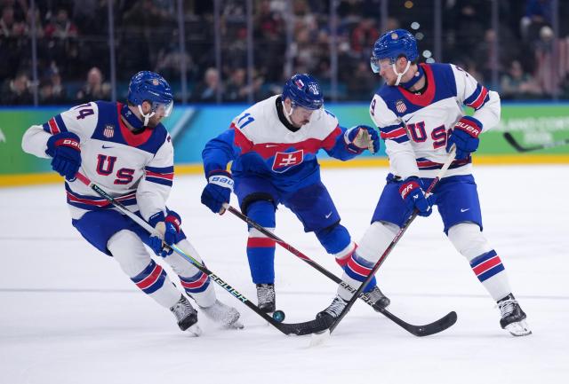 (260221) -- MILAN, Feb. 21, 2026 (Xinhua) -- Milos Kelemen (C) of Slovakia battles for the puck with Jaccob Slavin (L) and Jack Eichel of the United States during the ice hockey men's play-offs semifinal match between the United States and Slovakia at the Milan-Cortina 2026 Olympic Winter Games in Milan, Italy, Feb. 20, 2026. (Xinhua/Tao Xiyi)