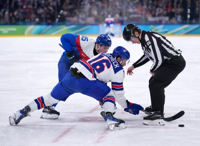 (260221) -- MILAN, Feb. 21, 2026 (Xinhua) -- Vincent Trocheck (C) of the United States and Dalibor Dvorsky (L) of Slovakia battle for the puck during the ice hockey men's play-offs semifinal match between the United States and Slovakia at the Milan-Cortina 2026 Olympic Winter Games in Milan, Italy, Feb. 20, 2026. (Xinhua/Tao Xiyi)