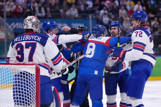 (260221) -- MILAN, Feb. 21, 2026 (Xinhua) -- Players of both teams fight during the ice hockey men's play-offs semifinal match between the United States and Slovakia at the Milan-Cortina 2026 Olympic Winter Games in Milan, Italy, Feb. 20, 2026. (Xinhua/Tao Xiyi)