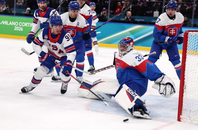 (260221) -- MILAN, Feb. 21, 2026 (Xinhua) -- Stanislav Skorvanek (2nd R), goalkeeper of Slovakia makes a save during the ice hockey men's play-offs semifinal match between the United States and Slovakia at the Milan-Cortina 2026 Olympic Winter Games in Milan, Italy, Feb. 20, 2026. (Xinhua/Wang Kaiyan)