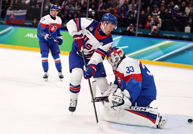 (260221) -- MILAN, Feb. 21, 2026 (Xinhua) -- Brady Tkachuk (C) of the United States shoots to score during the ice hockey men's play-offs semifinal match between the United States and Slovakia at the Milan-Cortina 2026 Olympic Winter Games in Milan, Italy, Feb. 20, 2026. (Xinhua/Wang Kaiyan)