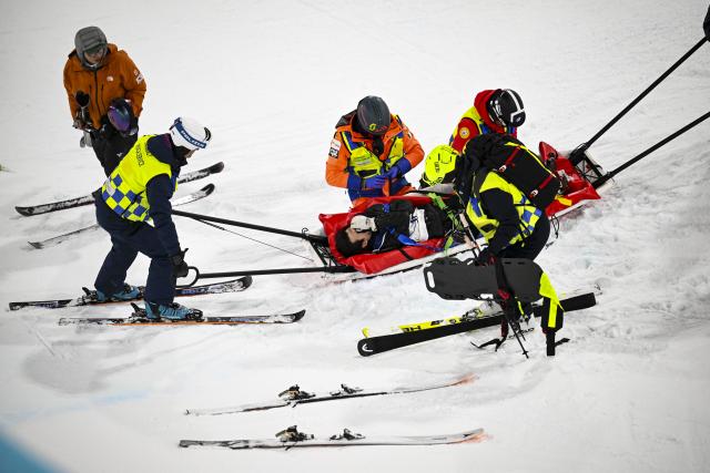 (260221) -- LIVIGNO, Feb. 21, 2026 (Xinhua) -- Lee Seunghun of South Korea gets injured during the training session before the freestyle skiing men's freeski halfpipe final at the Milan-Cortina 2026 Olympic Winter Games in Livigno, Italy, Feb. 20, 2026. (Xinhua/Xia Yifang)