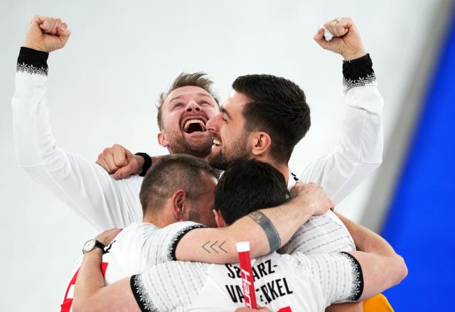 (260221) -- CORTINA D'AMPEZZO, Feb. 21, 2026 (Xinhua) -- Players of Switzerland celebrate victory after winning the curling men's bronze medal game between Norway and Switzerland at the 2026 Milan-Cortina Winter Olympics in Cortina, Italy, Feb. 20, 2026. (Xinhua/Li Gang)