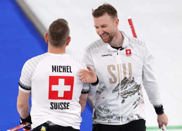 (260221) -- CORTINA D'AMPEZZO, Feb. 21, 2026 (Xinhua) -- Yannick Schwaller (R) and Sven Michel of Switzerland react during the curling men's bronze medal game between Norway and Switzerland at the 2026 Milan-Cortina Winter Olympics in Cortina, Italy, Feb. 20, 2026. (Xinhua/Zhang Chenlin)