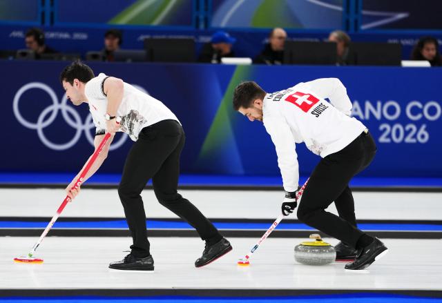 (260221) -- CORTINA D'AMPEZZO, Feb. 21, 2026 (Xinhua) -- Pablo Lachat-Couchepin (R) of Switzerland competes during the curling men's bronze medal game between Norway and Switzerland at the 2026 Milan-Cortina Winter Olympics in Cortina, Italy, Feb. 20, 2026. (Xinhua/Li Gang)