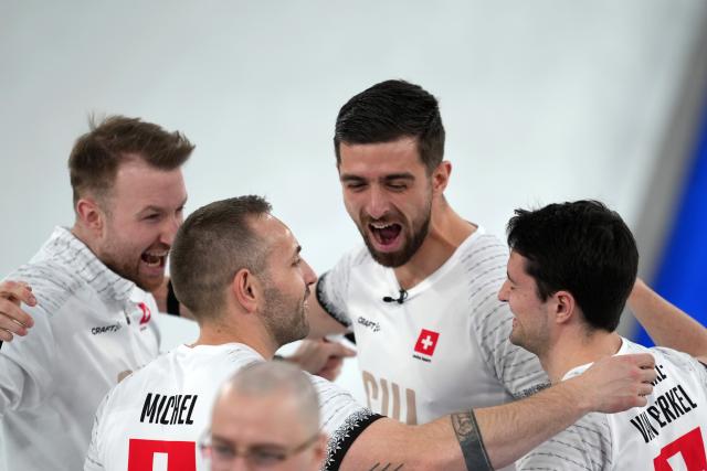 (260221) -- CORTINA D'AMPEZZO, Feb. 21, 2026 (Xinhua) -- Players of Switzerland celebrate victory after winning the curling men's bronze medal game between Norway and Switzerland at the 2026 Milan-Cortina Winter Olympics in Cortina, Italy, Feb. 20, 2026. (Xinhua/Li Gang)