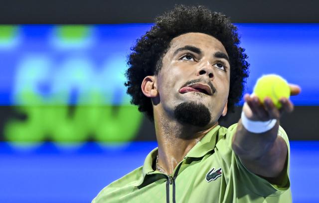 (260221) -- DOHA, Feb. 21, 2026 (Xinhua) -- Arthur Fils serves during the men's singles semi-final match between Jakub Mensik of the Czech Republic and Arthur Fils of France at the ATP Qatar Open 2026 tennis tournament in Doha, Qatar, on Feb. 20, 2026. (Photo by Nikku/Xinhua)