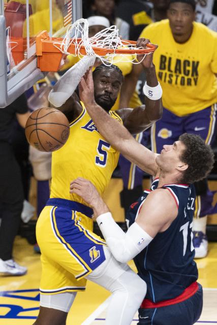 (260221) -- LOS ANGELES, Feb. 21, 2026 (Xinhua) -- Los Angeles Lakers' Deandre Ayton (L) dunks against Los Angeles Clippers' Brook Lopez during the 2025-2026 NBA regular season basketball game between Los Angeles Lakers and Los Angeles Clippers in Los Angeles, the United States, Feb. 20, 2026. (Photo by Ringo Chiu/Xinhua)