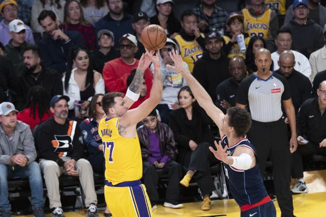 (260221) -- LOS ANGELES, Feb. 21, 2026 (Xinhua) -- Los Angeles Lakers' Luka Doncic (L) shoots against Los Angeles Clippers' Brook Lopez during the 2025-2026 NBA regular season basketball game between Los Angeles Lakers and Los Angeles Clippers in Los Angeles, the United States, Feb. 20, 2026. (Photo by Ringo Chiu/Xinhua)
