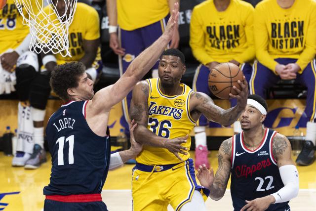 (260221) -- LOS ANGELES, Feb. 21, 2026 (Xinhua) -- Los Angeles Clippers' Brook Lopez (L) blocks Los Angeles Lakers' Marcus Smart (C) during the 2025-2026 NBA regular season basketball game between Los Angeles Lakers and Los Angeles Clippers in Los Angeles, the United States, Feb. 20, 2026. (Photo by Ringo Chiu/Xinhua)