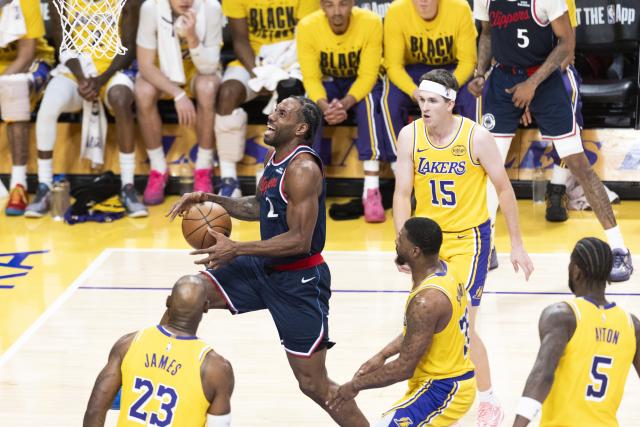 (260221) -- LOS ANGELES, Feb. 21, 2026 (Xinhua) -- Los Angeles Clippers' Kawhi Leonard (2nd L) goes for a layup during the 2025-2026 NBA regular season basketball game between Los Angeles Lakers and Los Angeles Clippers in Los Angeles, the United States, Feb. 20, 2026. (Photo by Ringo Chiu/Xinhua)