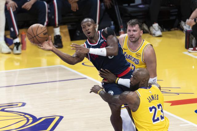 (260221) -- LOS ANGELES, Feb. 21, 2026 (Xinhua) -- Los Angeles Clippers' Kris Dunn (C) vies with Los Angeles Lakers' LeBron James (front) and Luka Doncic during the 2025-2026 NBA regular season basketball game between Los Angeles Lakers and Los Angeles Clippers in Los Angeles, the United States, Feb. 20, 2026. (Photo by Ringo Chiu/Xinhua)