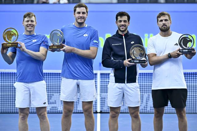 (260221) -- DOHA, Feb. 21, 2026 (Xinhua) -- Winners Harri Heliovaara (1st L)/Henry Patten (2nd L) and runners-up Julian Cash (2nd R)/Lloyd Glasspool pose for photos during the awarding ceremony of the men's doubles final match between Harri Heliovaara of Finland/Henry Patten of Britain and Julian Cash/Lloyd Glasspool of Britain at the ATP Qatar Open 2026 tennis tournament in Doha, Qatar, on Feb. 20, 2026. (Photo by Nikku/Xinhua)