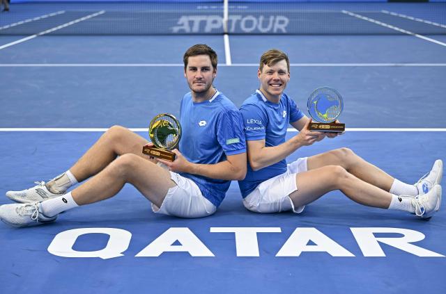 (260221) -- DOHA, Feb. 21, 2026 (Xinhua) -- Winners Harri Heliovaara (R)/Henry Patten pose for photos during the awarding ceremony of the men's doubles final match between Harri Heliovaara of Finland/Henry Patten of Britain and Julian Cash/Lloyd Glasspool of Britain at the ATP Qatar Open 2026 tennis tournament in Doha, Qatar, on Feb. 20, 2026. (Photo by Nikku/Xinhua)