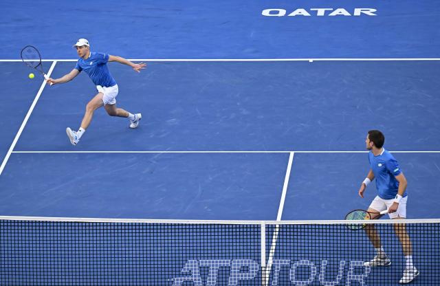 (260221) -- DOHA, Feb. 21, 2026 (Xinhua) -- Harri Heliovaara (L)/Henry Patten compete during the men's doubles final match between Harri Heliovaara of Finland/Henry Patten of Britain and Julian Cash/Lloyd Glasspool of Britain at the ATP Qatar Open 2026 tennis tournament in Doha, Qatar, on Feb. 20, 2026. (Photo by Nikku/Xinhua)