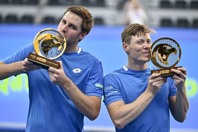 (260221) -- DOHA, Feb. 21, 2026 (Xinhua) -- Winners Harri Heliovaara (R)/Henry Patten pose for photos during the awarding ceremony of the men's doubles final match between Harri Heliovaara of Finland/Henry Patten of Britain and Julian Cash/Lloyd Glasspool of Britain at the ATP Qatar Open 2026 tennis tournament in Doha, Qatar, on Feb. 20, 2026. (Photo by Nikku/Xinhua)