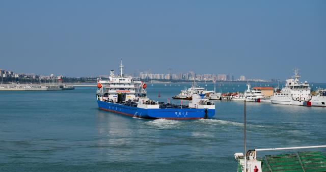 (260221) -- HAIKOU, Feb. 21, 2026 (Xinhua) -- A ferry carrying new energy vehicles departs Xiuying Port in Haikou, south China's Hainan Province, Feb. 21, 2026. Connecting south China's island province of Hainan with Guangdong Province on the mainland, the Qiongzhou Strait is bracing for a peak in return trips during this year's Spring Festival travel season. The number of outbound traffic leaving the island is expected to reach its maximum between Feb. 20 and 23. In Haikou, measures have been taken to ensure the safe and convenient return of passengers and vehicles via the Qiongzhou Strait. (Xinhua/Yang Guanyu)