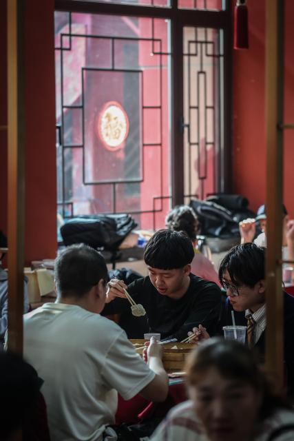 (260221) -- SHENYANG, Feb. 21, 2026 (Xinhua) -- Diners enjoy dumplings at Laobian Dumplings, a restaurant chain, in Shenyang, northeast China's Liaoning Province, Feb. 21, 2026. On the fifth day of the Chinese lunar new year, also known as "Powu," a dumpling-eating tradition is observed in many regions across China to ward off evil and disaster, embrace good fortune, and express hopes for the new year. (Xinhua/Pan Yulong)
