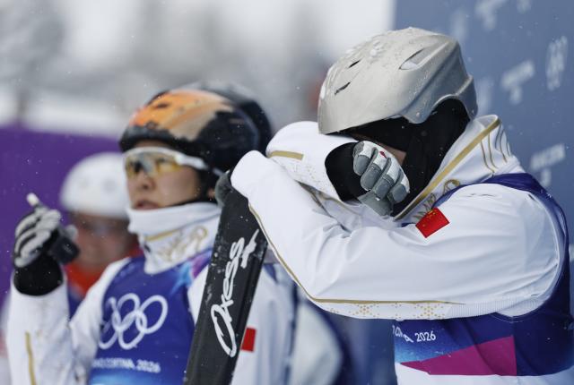 (260221) -- LIVIGNO, Feb. 21, 2026 (Xinhua) -- Wang Xindi (R) of China reacts during the freestyle skiing mixed team aerials final 2 at the Milan-Cortina 2026 Olympic Winter Games in Livigno, Italy, Feb. 21, 2026. (Xinhua/Wang Peng)
