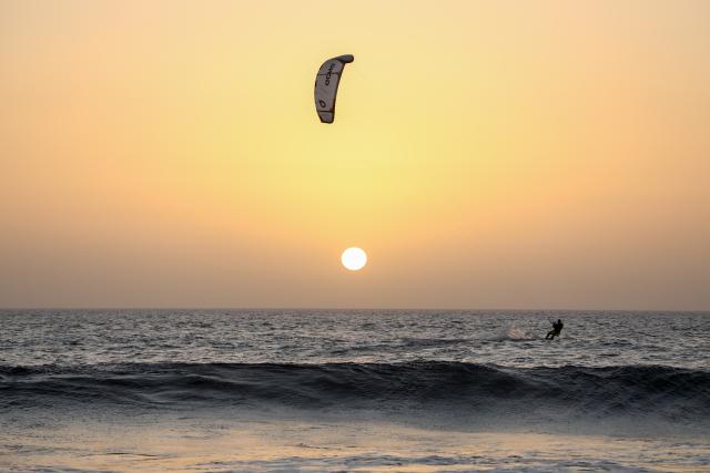 (260221) -- SAL ISLAND, Feb. 21, 2026 (Xinhua) -- A kitesurfer rides on the sea at sunset off Sal Island, Cape Verde, Feb. 20, 2026. (Photo by Elton Monteiro/Xinhua)