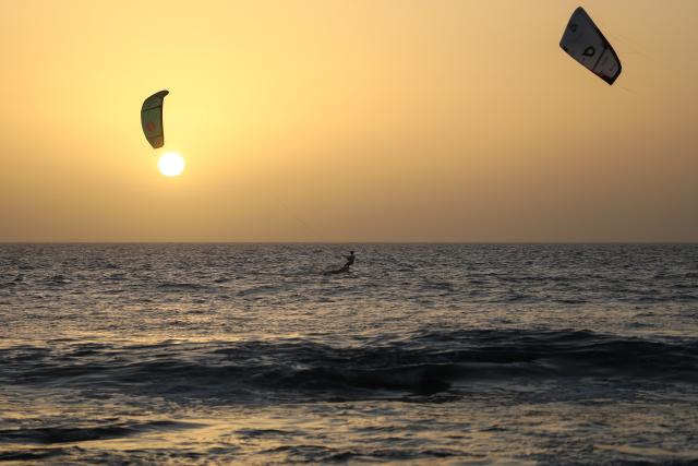 (260221) -- SAL ISLAND, Feb. 21, 2026 (Xinhua) -- A kitesurfer rides on the sea at sunset off Sal Island, Cape Verde, Feb. 20, 2026. (Photo by Elton Monteiro/Xinhua)