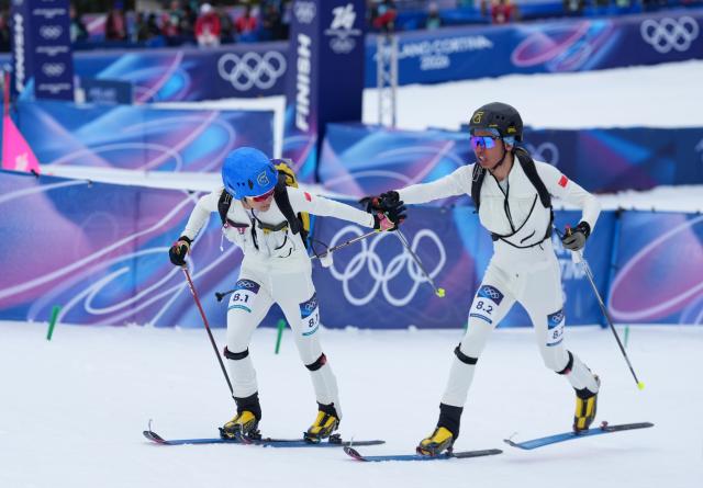 (260221) -- BORMIO, Feb. 21, 2026 (Xinhua) -- Cidan Yuzhen (L) and her teammate Bu Luer of China compete during the ski mountaineering mixed relay event at the Milan-Cortina 2026 Olympic Winter Games in Bormio, Italy, Feb. 21, 2026. (Xinhua/Hu Huhu)