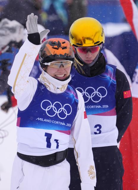 (260221) -- LIVIGNO, Feb. 21, 2026 (Xinhua) -- Xu Mengtao and Li Tianma (R) of China react after the freestyle skiing mixed team aerials final 2 at the Milan-Cortina 2026 Olympic Winter Games in Livigno, Italy, Feb. 21, 2026. (Xinhua/Hu Chao)