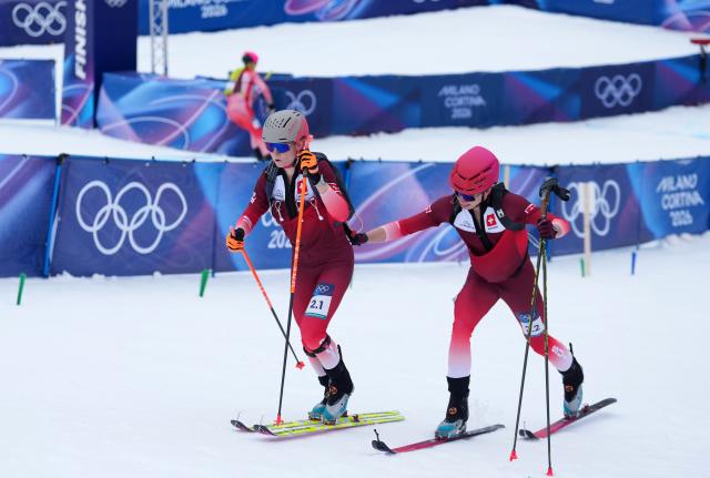 (260221) -- BORMIO, Feb. 21, 2026 (Xinhua) -- Jon Kistler (R) of Switzerland and his teammate Marianne Fatton compete during the ski mountaineering mixed relay event at the Milan-Cortina 2026 Olympic Winter Games in Bormio, Italy, Feb. 21, 2026. (Xinhua/Hu Huhu)