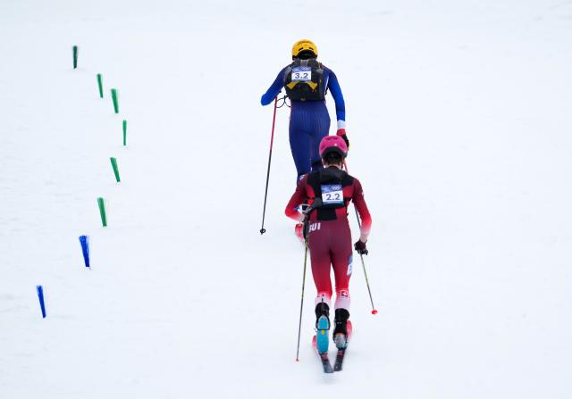 (260221) -- BORMIO, Feb. 21, 2026 (Xinhua) -- Thibault Anselmet (L) of France and Jon Kistler of Switzerland compete during the ski mountaineering mixed relay event at the Milan-Cortina 2026 Olympic Winter Games in Bormio, Italy, Feb. 21, 2026. (Xinhua/Hu Huhu)