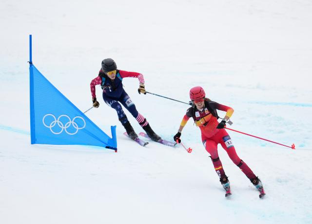 (260221) -- BORMIO, Feb. 21, 2026 (Xinhua) -- Ana Alonso Rodriguez (R) of Spain and Anna Gibson of the United States compete during the ski mountaineering mixed relay event at the Milan-Cortina 2026 Olympic Winter Games in Bormio, Italy, Feb. 21, 2026. (Xinhua/Hu Huhu)