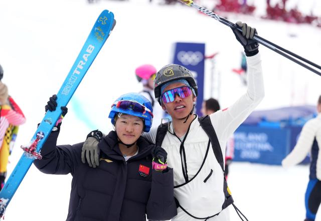 (260221) -- BORMIO, Feb. 21, 2026 (Xinhua) -- Cidan Yuzhen (L) of China and her teammate Bu Luer pose after the ski mountaineering mixed relay event at the Milan-Cortina 2026 Olympic Winter Games in Bormio, Italy, Feb. 21, 2026. (Xinhua/Hu Huhu)