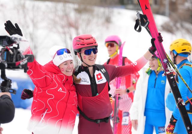 (260221) -- BORMIO, Feb. 21, 2026 (Xinhua) -- Jon Kistler (R) of Switzerland and his teammate Marianne Fatton pose after the ski mountaineering mixed relay event at the Milan-Cortina 2026 Olympic Winter Games in Bormio, Italy, Feb. 21, 2026. (Xinhua/Hu Huhu)