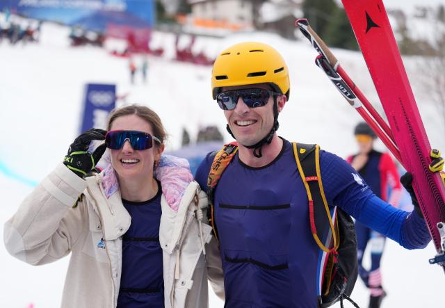 (260221) -- BORMIO, Feb. 21, 2026 (Xinhua) -- Thibault Anselmet (R) of France and his teammate Emily Harrop pose after the ski mountaineering mixed relay event at the Milan-Cortina 2026 Olympic Winter Games in Bormio, Italy, Feb. 21, 2026. (Xinhua/Hu Huhu)