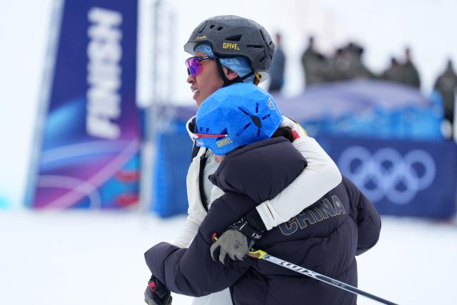 (260221) -- BORMIO, Feb. 21, 2026 (Xinhua) -- Cidan Yuzhen (bottom) of China and her teammate Bu Luer react after the ski mountaineering mixed relay event at the Milan-Cortina 2026 Olympic Winter Games in Bormio, Italy, Feb. 21, 2026. (Xinhua/Hu Huhu)