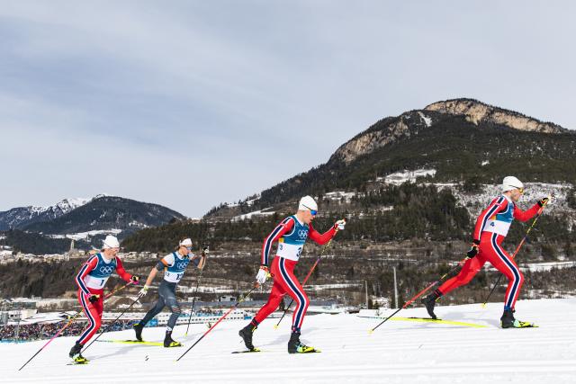 (260221) -- TESERO, Feb. 21, 2026 (Xinhua) -- Johannes Hoesflot Klaebo (1st L) of Norway and his teammate Emil Iversen of Norway (1st R) and Martin Loewstroem Nyenget (2nd R) of Norway compete during the cross-country skiing men's 50km mass start classic match at the Milan-Cortina 2026 Olympic Winter Games in Tesero, Italy, Feb. 21, 2026. (Xinhua/Huang Wei)