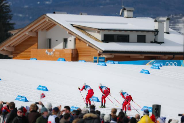 (260221) -- TESERO, Feb. 21, 2026 (Xinhua) -- Johannes Hoesflot Klaebo (R) of Norway and his teammate Emil Iversen of Norway (L) and Martin Loewstroem Nyenget of Norway compete during the cross-country skiing men's 50km mass start classic match at the Milan-Cortina 2026 Olympic Winter Games in Tesero, Italy, Feb. 21, 2026. (Xinhua/Huang Wei)