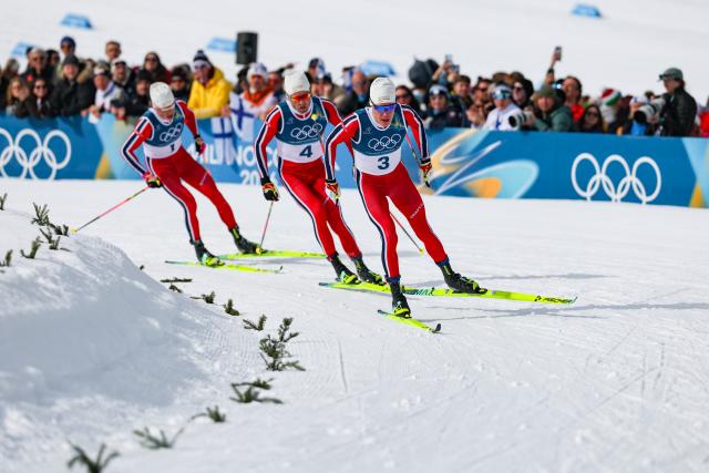 (260221) -- TESERO, Feb. 21, 2026 (Xinhua) -- Johannes Hoesflot Klaebo (L) of Norway and his teammate Emil Iversen of Norway (C) and Martin Loewstroem Nyenget of Norway compete during the cross-country skiing men's 50km mass start classic match at the Milan-Cortina 2026 Olympic Winter Games in Tesero, Italy, Feb. 21, 2026. (Xinhua/Huang Wei)