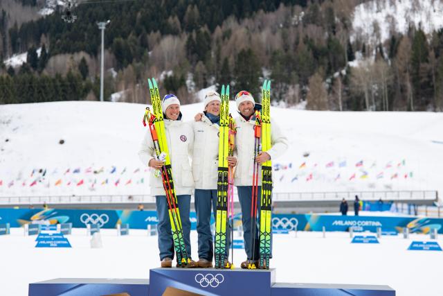 (260221) -- TESERO, Feb. 21, 2026 (Xinhua) -- Gold medalist Johannes Hoesflot Klaebo (C) of Norway, silver medalist Martin Loewstroem Nyenget (L) of Norway and bronze medalist Emil Iversen of Norway pose on the podium after the cross-country skiing men's 50km mass start classic event at the Milan-Cortina 2026 Olympic Winter Games in Tesero, Italy, Feb. 21, 2026. (Xinhua/Huang Wei)