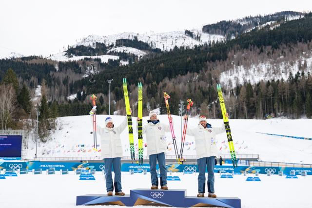 (260221) -- TESERO, Feb. 21, 2026 (Xinhua) -- Gold medalist Johannes Hoesflot Klaebo (C) of Norway, silver medalist Martin Loewstroem Nyenget (L) of Norway and bronze medalist Emil Iversen of Norway pose on the podium after the cross-country skiing men's 50km mass start classic event at the Milan-Cortina 2026 Olympic Winter Games in Tesero, Italy, Feb. 21, 2026. (Xinhua/Huang Wei)