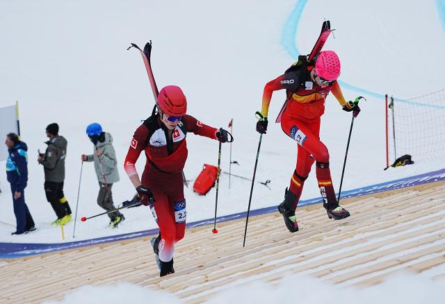 (260221) -- BORMIO, Feb. 21, 2026 (Xinhua) -- Oriol Cardona Coll (R) of Spain and Jon Kistler of Switzerland compete during the ski mountaineering mixed relay event at the Milan-Cortina 2026 Olympic Winter Games in Bormio, Italy, Feb. 21, 2026. (Xinhua/Yan Linyun)