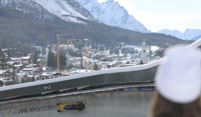 (260221) -- CORTINA D'AMPEZZO, Feb. 21, 2026 (Xinhua) -- Adam Ammour/Issam Ammour/Joshua Tasche/Alexander Schaller of Germany compete during the Bobsleigh 4-man heat 1 at the 2026 Milan-Cortina Winter Olympics in Cortina D'Ampezzo, Italy, Feb. 21, 2026. (Xinhua/Ding Xu)