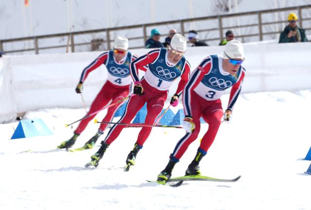 (260221) -- TESERO, Feb. 21, 2026 (Xinhua) -- Johannes Hoesflot Klaebo (C), Martin Loewstroem Nyenget (R) and Emil Iversen of Norway compete during the cross-country skiing men's 50km mass start classic match at the Milan-Cortina 2026 Olympic Winter Games in Tesero, Italy, Feb. 21, 2026. (Xinhua/Meng Yongmin)