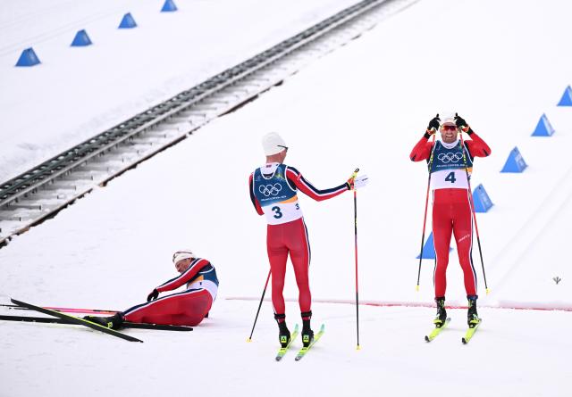(260221) -- TESERO, Feb. 21, 2026 (Xinhua) -- Martin Loewstroem Nyenget (C) and Emil Iversen of Norway react after the cross-country skiing men's 50km mass start classic match at the Milan-Cortina 2026 Olympic Winter Games in Tesero, Italy, Feb. 21, 2026. (Xinhua/He Canling)