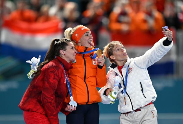 (260221) -- MILAN, Feb. 21, 2026 (Xinhua) -- Gold medalist Marijke Groenewoud (C) of the Netherlands, silver medalist Ivanie Blondin (L) of Canada, and bronze medalist Mia Manganello of the United States take a selfie during the awarding ceremony of the speed skating women's mass start event at the Milan-Cortina 2026 Olympic Winter Games in Milan, Italy, Feb. 21, 2026. (Xinhua/Wu Wei)