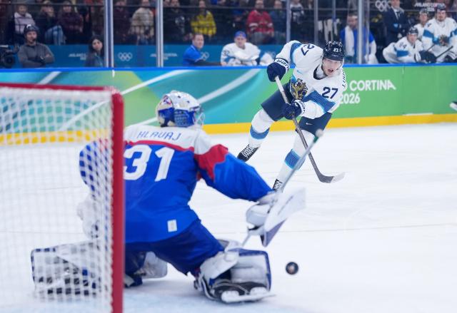 (260221) -- MILAN, Feb. 21, 2026 (Xinhua) -- Eetu Luostarinen of Finland shoots during the ice hockey men's bronze medal game between Slovakia and Finland at the Milan-Cortina 2026 Olympic Winter Games in Milan, Italy, Feb. 21, 2026. (Xinhua/Tao Xiyi)