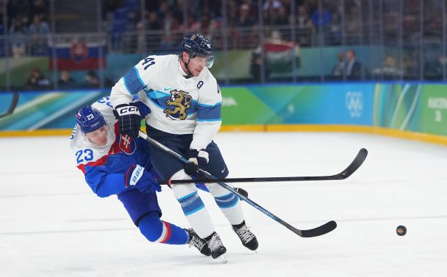 (260221) -- MILAN, Feb. 21, 2026 (Xinhua) -- Adam Liska of Slovakia vies with Miro Heiskanen (R) of Finland during the ice hockey men's bronze medal game between Slovakia and Finland at the Milan-Cortina 2026 Olympic Winter Games in Milan, Italy, Feb. 21, 2026. (Xinhua/Tao Xiyi)