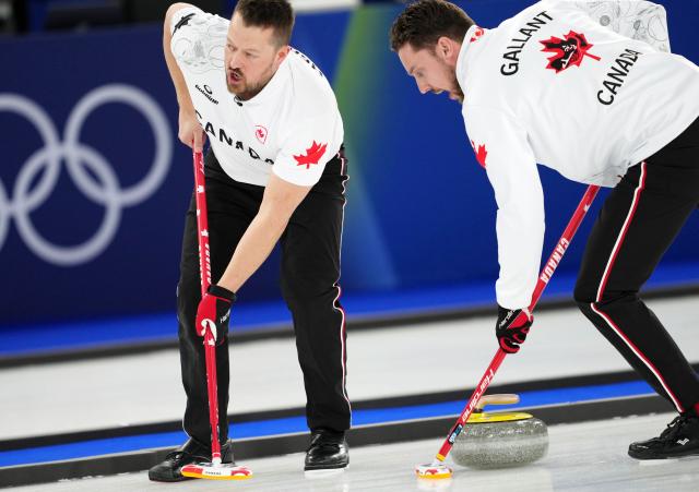 (260221) -- CORTINA D'AMPEZZO, Feb. 21, 2026 (Xinhua) -- Ben Hebert (L) and Brett Gallant of Canada compete during the curling men's gold medal game between Canada and Britain at the 2026 Milan-Cortina Winter Olympics in Cortina, Italy, Feb. 21, 2026. (Xinhua/Li Gang)