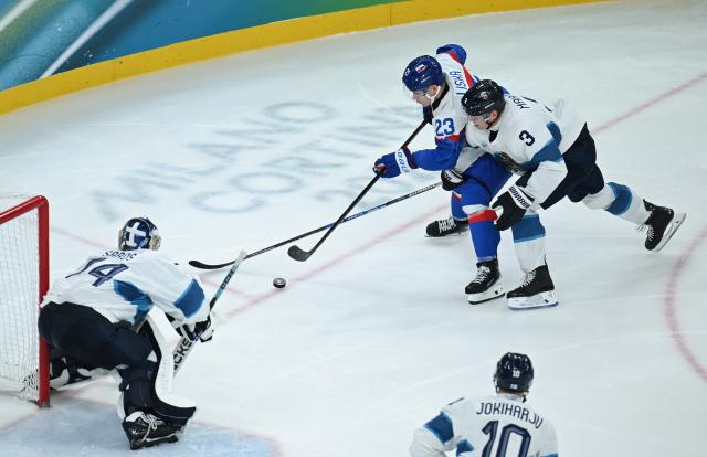 (260221) -- MILAN, Feb. 21, 2026 (Xinhua) -- Adam Liska of Slovakia vies with Olli Maatta (1st R) of Finland during the ice hockey men's bronze medal game between Slovakia and Finland at the Milan-Cortina 2026 Olympic Winter Games in Milan, Italy, Feb. 21, 2026. (Xinhua/Zhang Haofu)