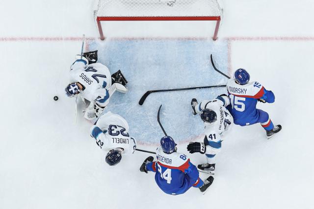 (260222) -- MILAN, Feb. 22, 2026 (Xinhua) -- Players of both teams battle for the puck during the ice hockey men's bronze medal game between Slovakia and Finland at the Milan-Cortina 2026 Olympic Winter Games in Milan, Italy, Feb. 21, 2026. (Xinhua/Zhang Haofu)